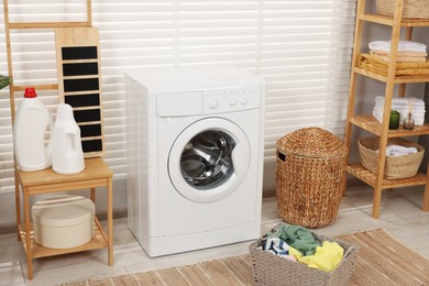 Laundry room interior with washing machine and baskets