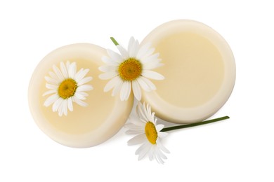 Photo of Solid shampoo bars and chamomiles on white background, top view. Hair care