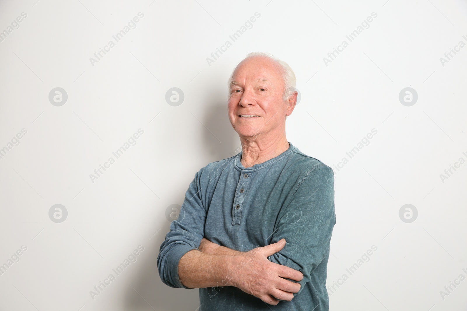 Photo of Portrait of elderly man on light background