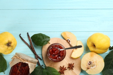 Composition with delicious quince jam and fruits on light blue wooden table, flat lay. Space for text