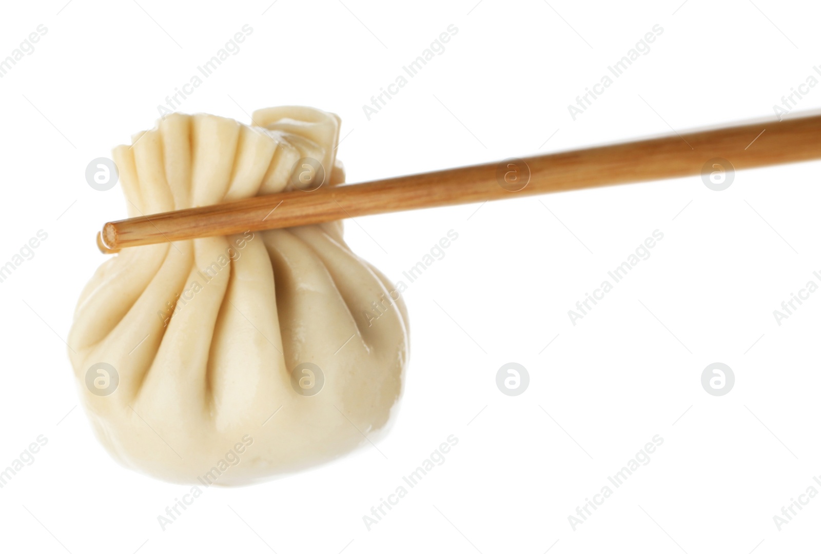 Photo of Chopsticks with tasty dumpling isolated on white