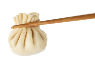 Photo of Chopsticks with tasty dumpling isolated on white