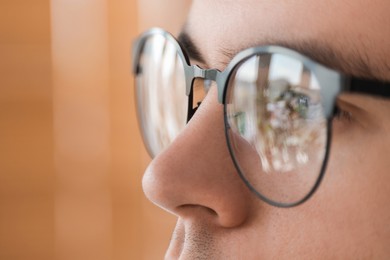 Photo of Man wearing glasses on blurred background, closeup