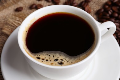 Photo of Cup of hot aromatic coffee, closeup view
