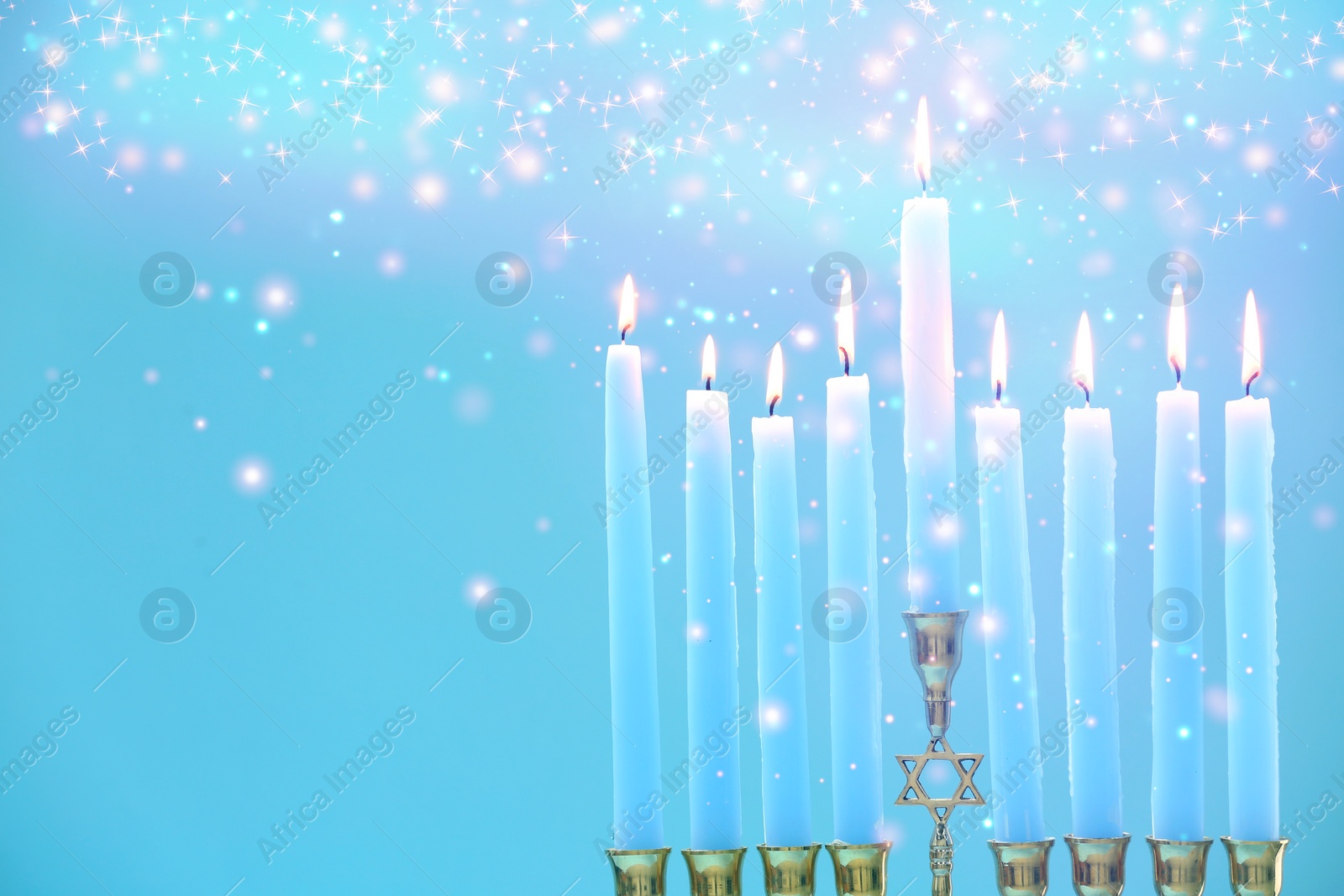 Image of Hanukkah celebration. Menorah with burning candles on light blue background, closeup. Space for text