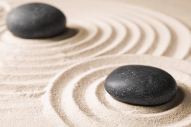 Zen garden stones on sand with pattern. Meditation and harmony