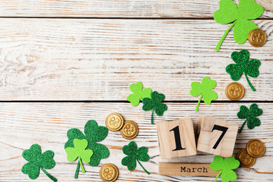 Flat lay composition with block calendar on white wooden background, space for text. St. Patrick's Day celebration