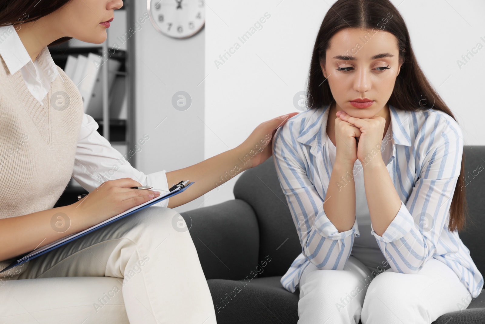 Photo of Professional psychologist working with young woman in office