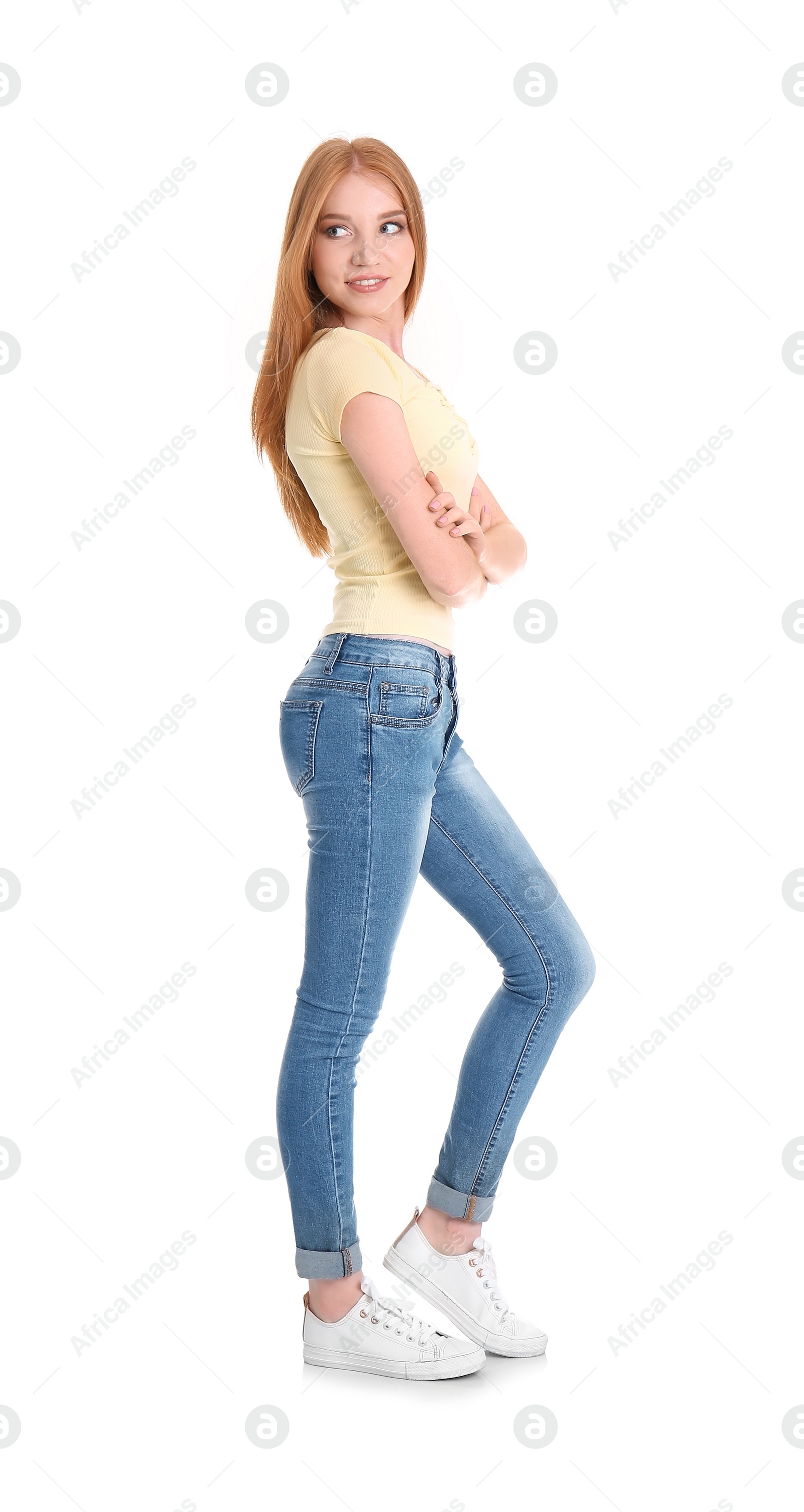 Photo of Young woman in stylish jeans on white background