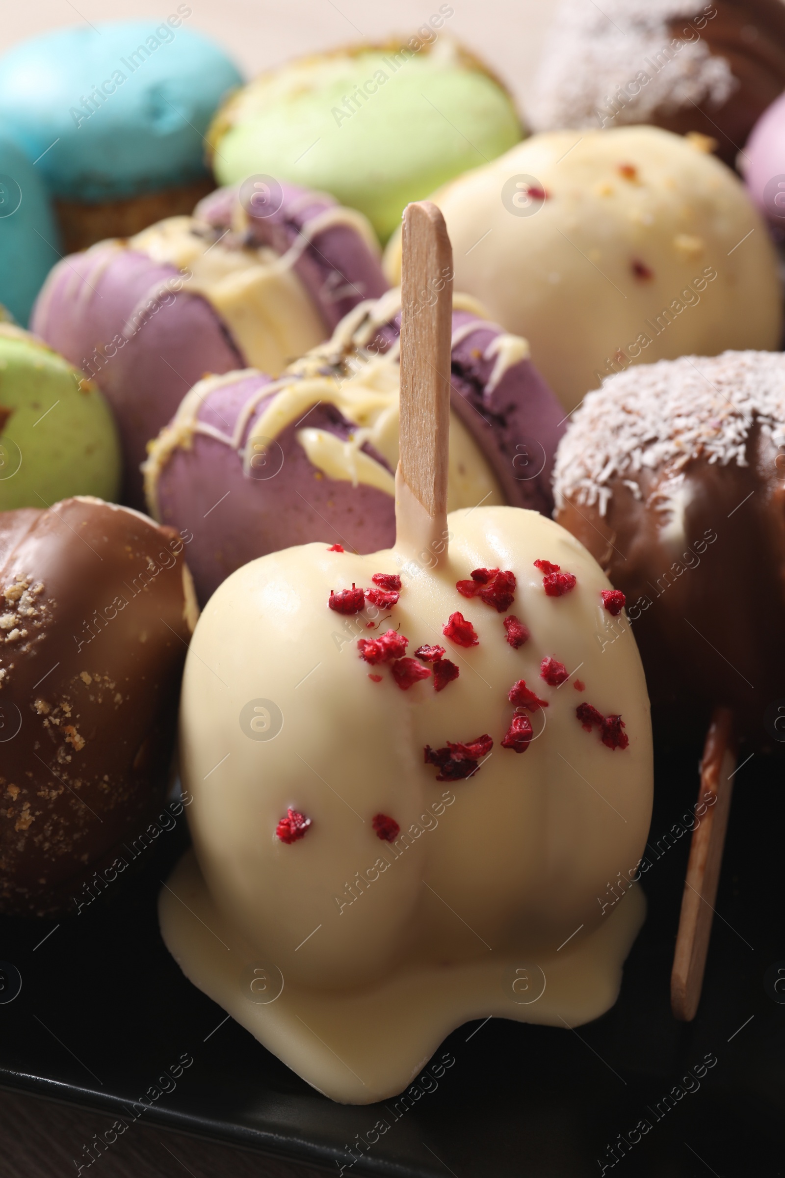 Photo of Delicious colorful macarons on plate, closeup view