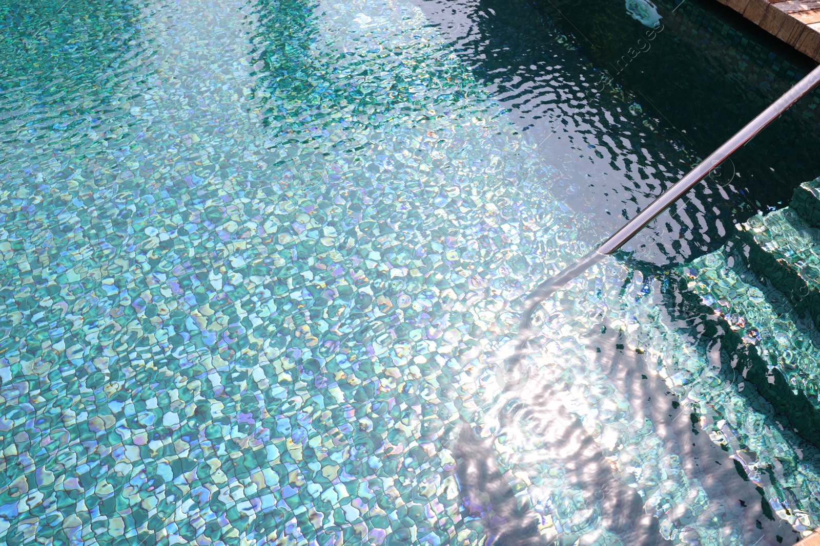 Photo of Outdoor swimming pool with steps and rail at resort