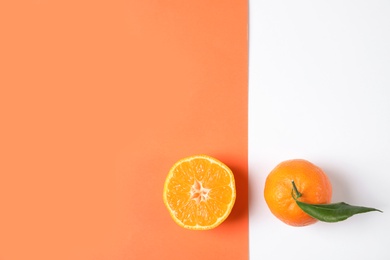 Photo of Flat lay composition with ripe tangerines on color background. Space for text