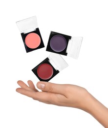 Image of Woman making eyeshadows levitate on white background, closeup. Decorative cosmetics