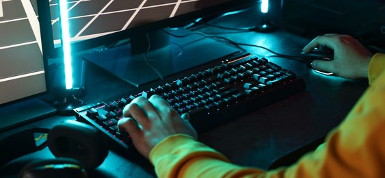 Photo of Man playing video games on computer indoors, closeup