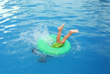 Little child with inflatable ring in outdoor swimming pool. Dangerous situation