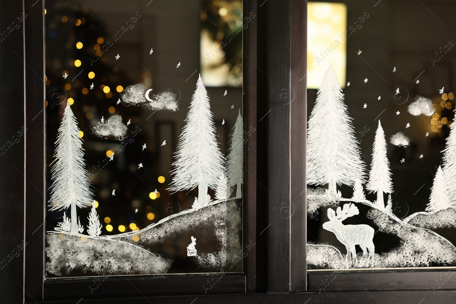 Photo of Beautiful drawing made with artificial snow on window. Christmas decor