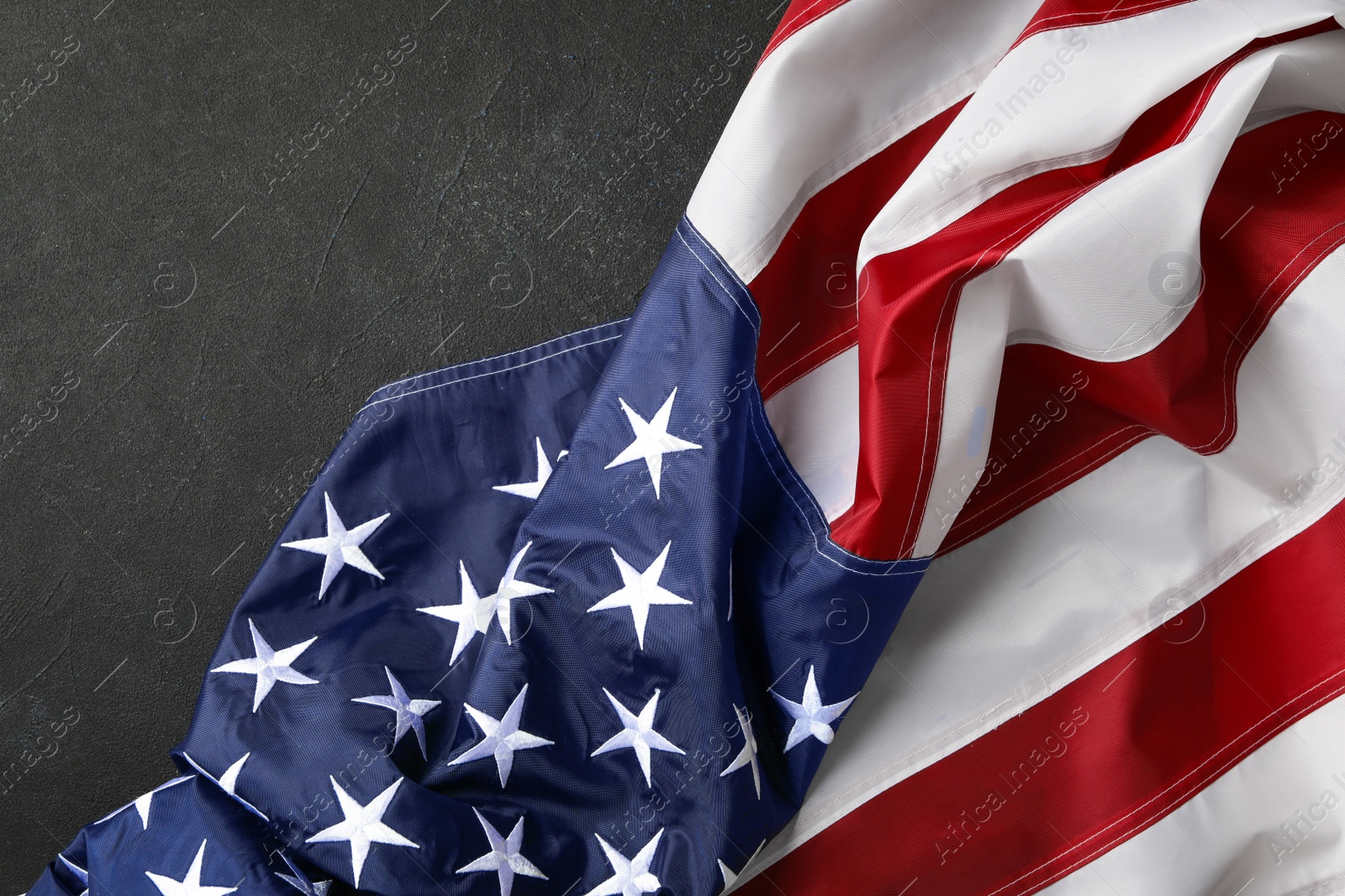 Photo of American flag on black table, top view. Memorial Day