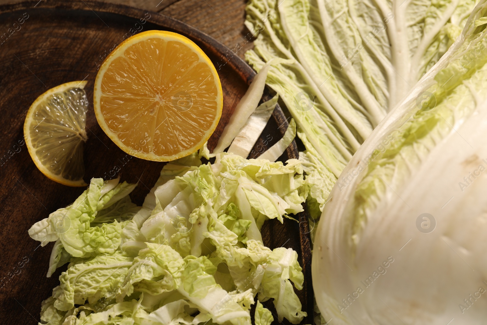 Photo of Fresh Chinese cabbage and lemon on table, top view