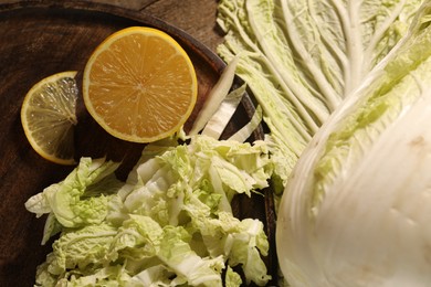 Photo of Fresh Chinese cabbage and lemon on table, top view