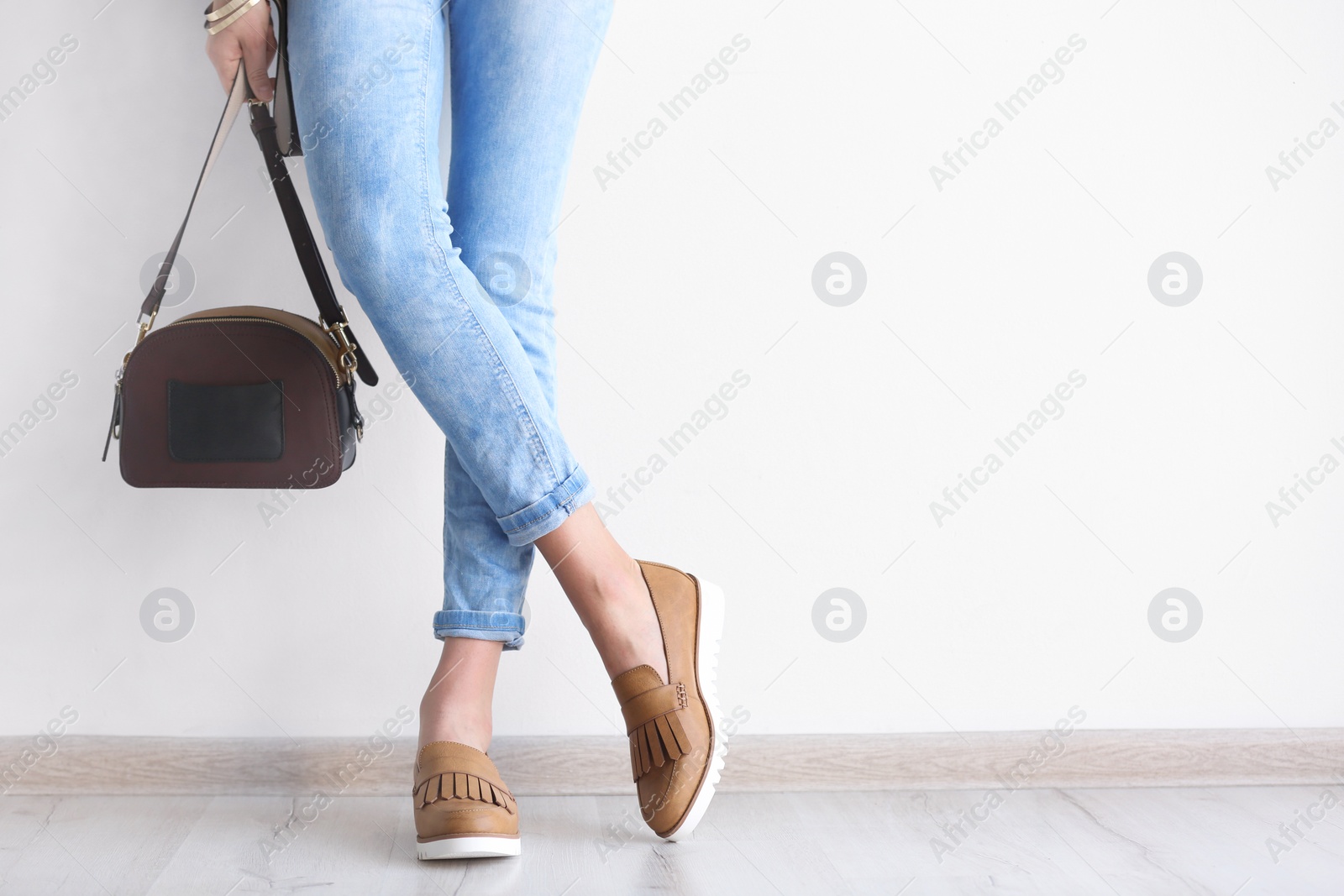 Photo of Young woman wearing elegant shoes indoors, closeup