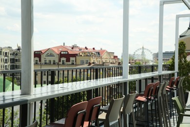 Photo of Observation area cafe. Chairs on terrace against beautiful cityscape