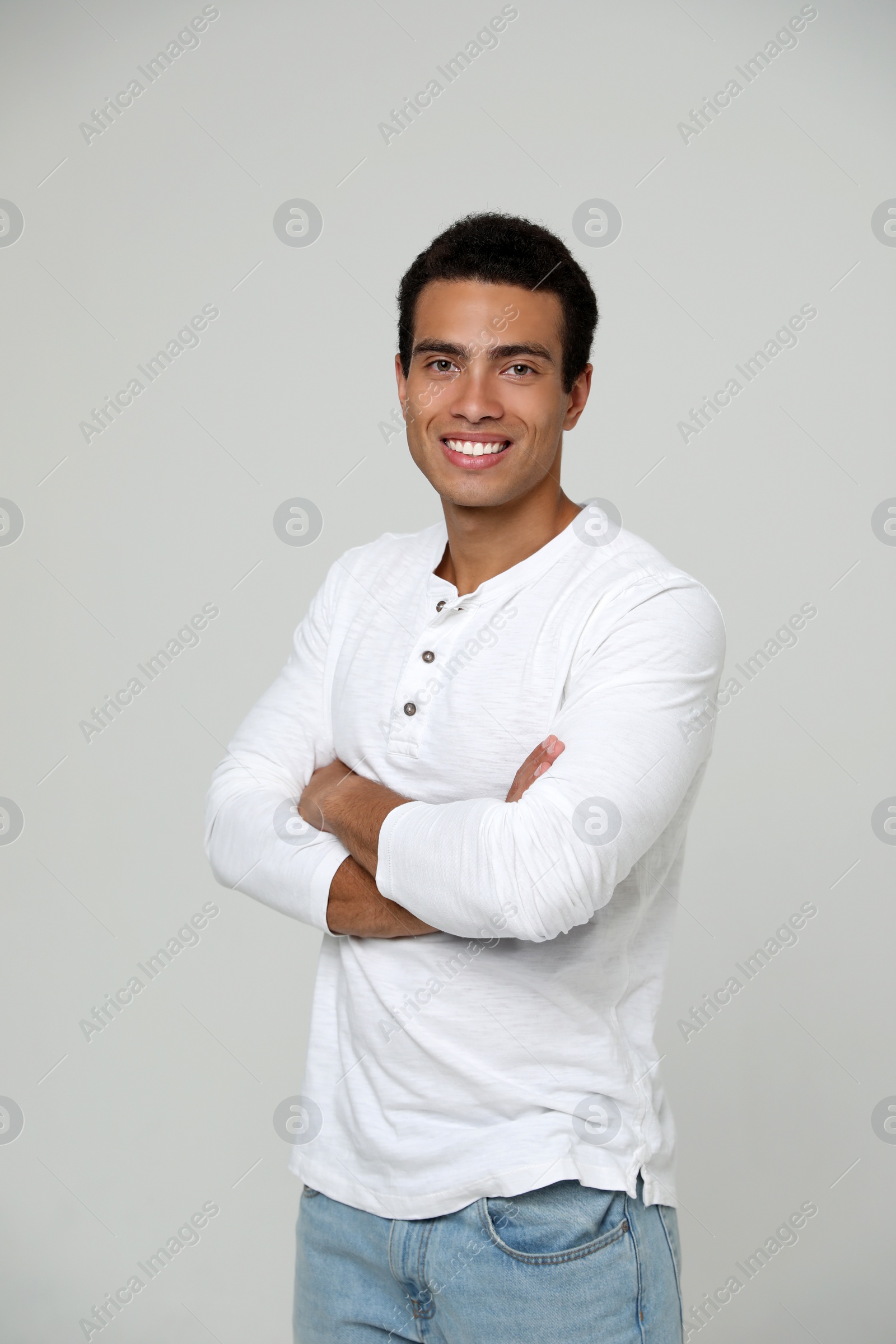 Photo of Handsome young African-American man on light background