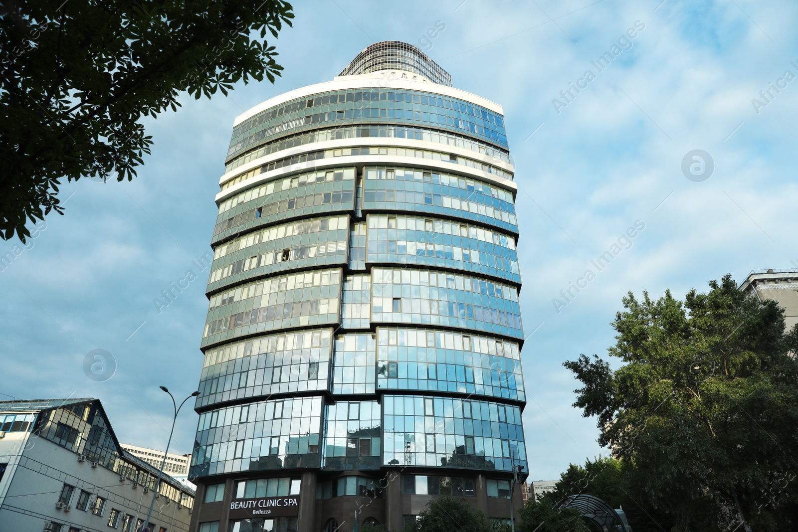 Photo of KYIV, UKRAINE - MAY 23, 2019: Modern office building against blue sky