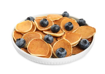Photo of Delicious mini pancakes cereal with blueberries on white background