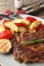 Delicious grilled beef steak and vegetables on plate, closeup