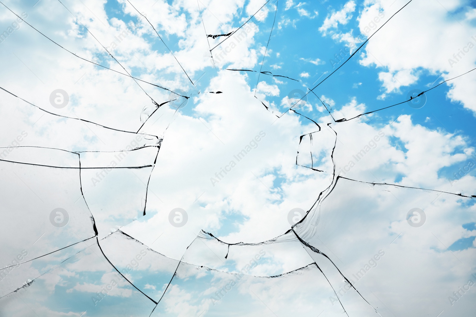 Image of View through broken window on cloudy sky