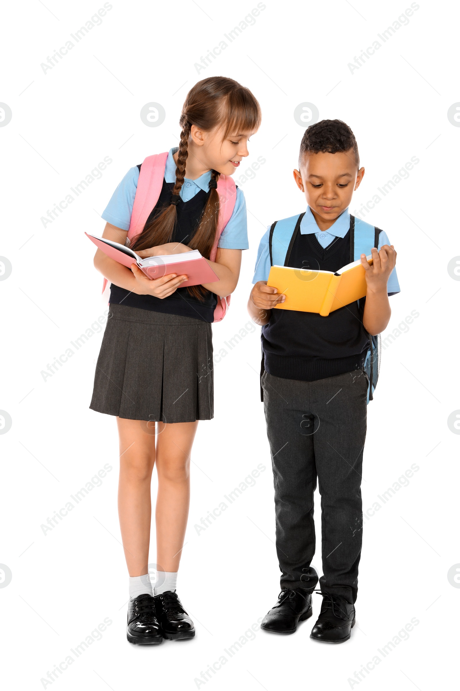 Photo of Full length portrait of cute children in school uniform on white background