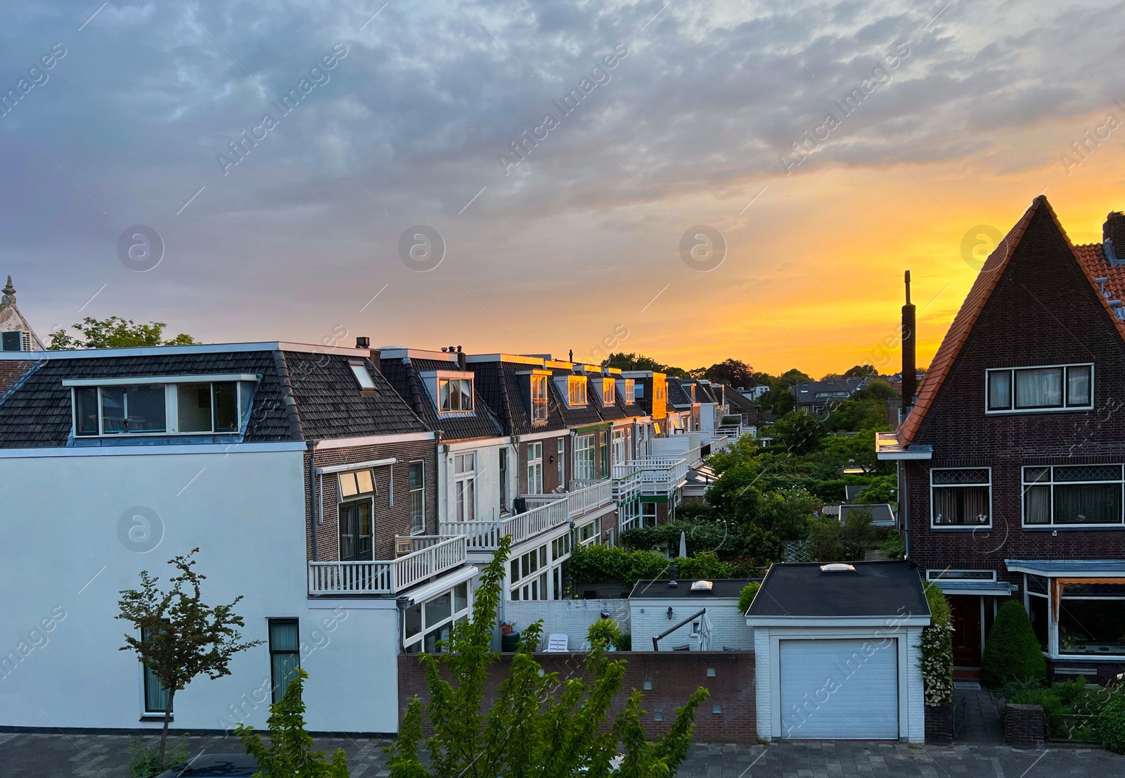 Photo of Picturesque view of city street with beautiful buildings at sunrise