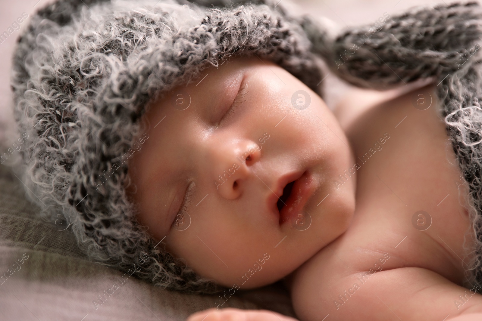 Photo of Cute newborn baby sleeping on bed, closeup