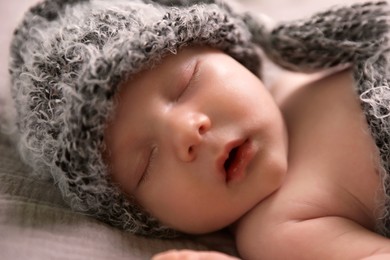 Photo of Cute newborn baby sleeping on bed, closeup