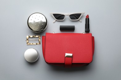 Flat lay composition with stylish woman's bag on light background