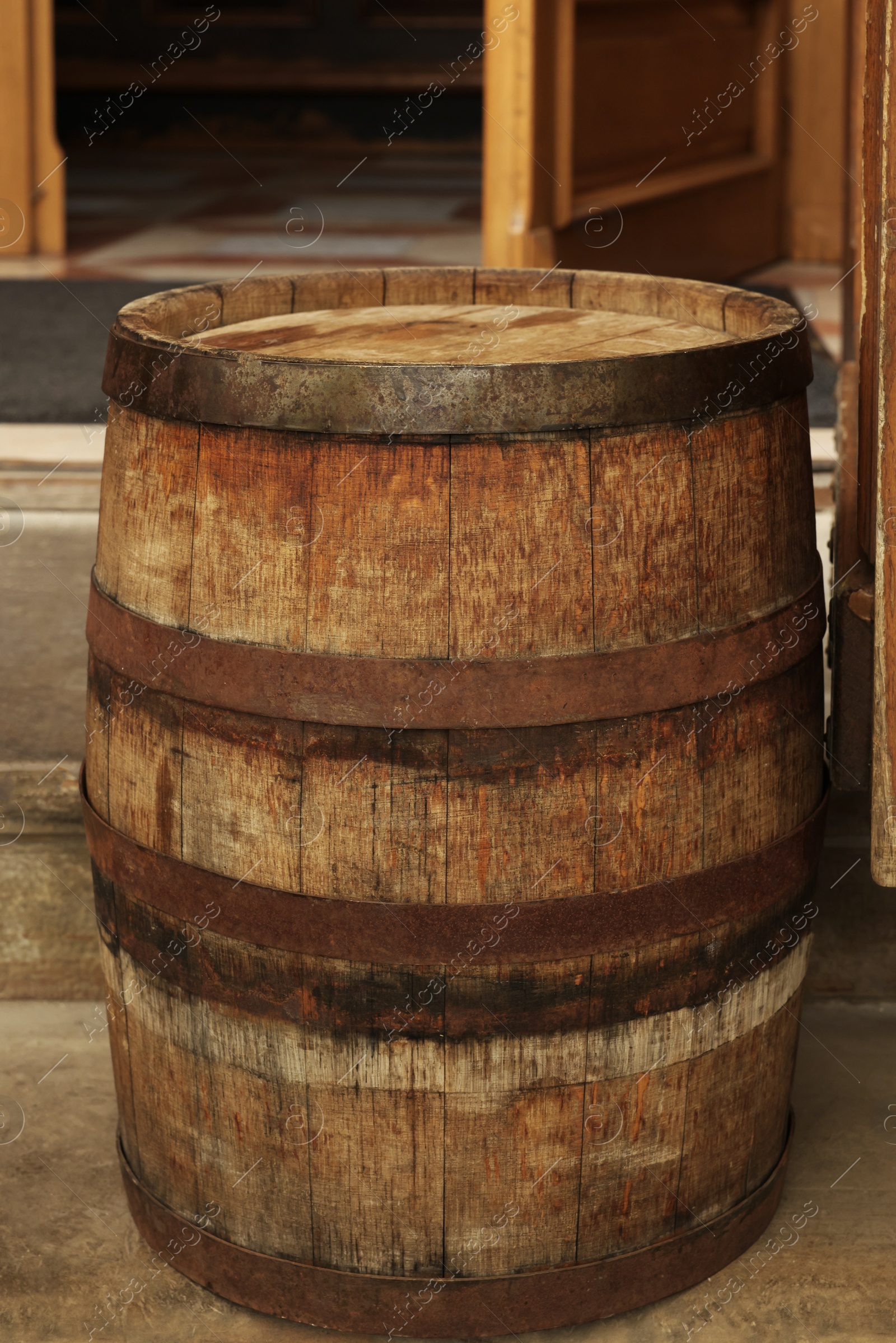 Photo of Traditional wooden barrel on street outdoors. Wine making