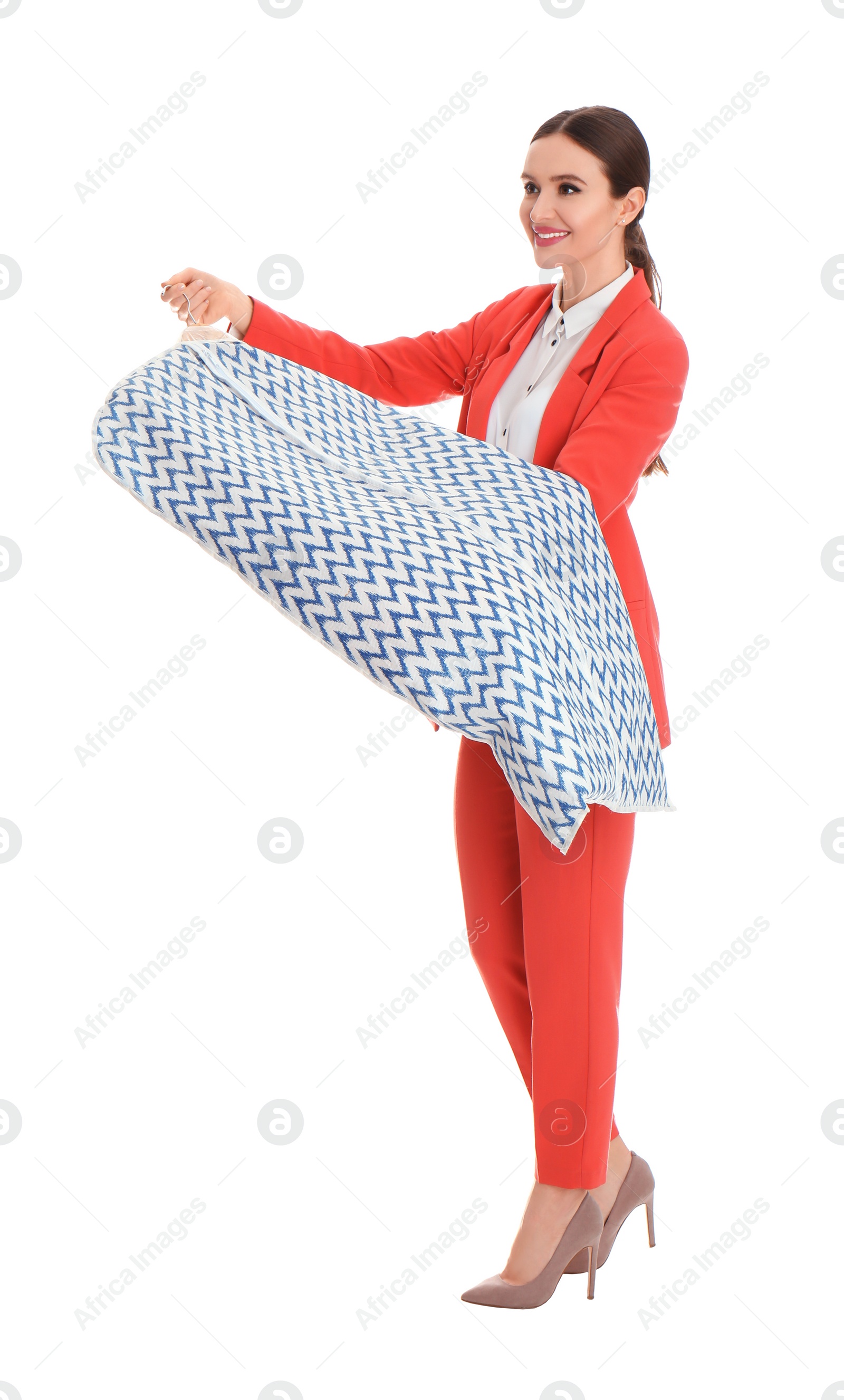 Photo of Young woman holding hanger with clothes in garment cover on white background. Dry-cleaning service