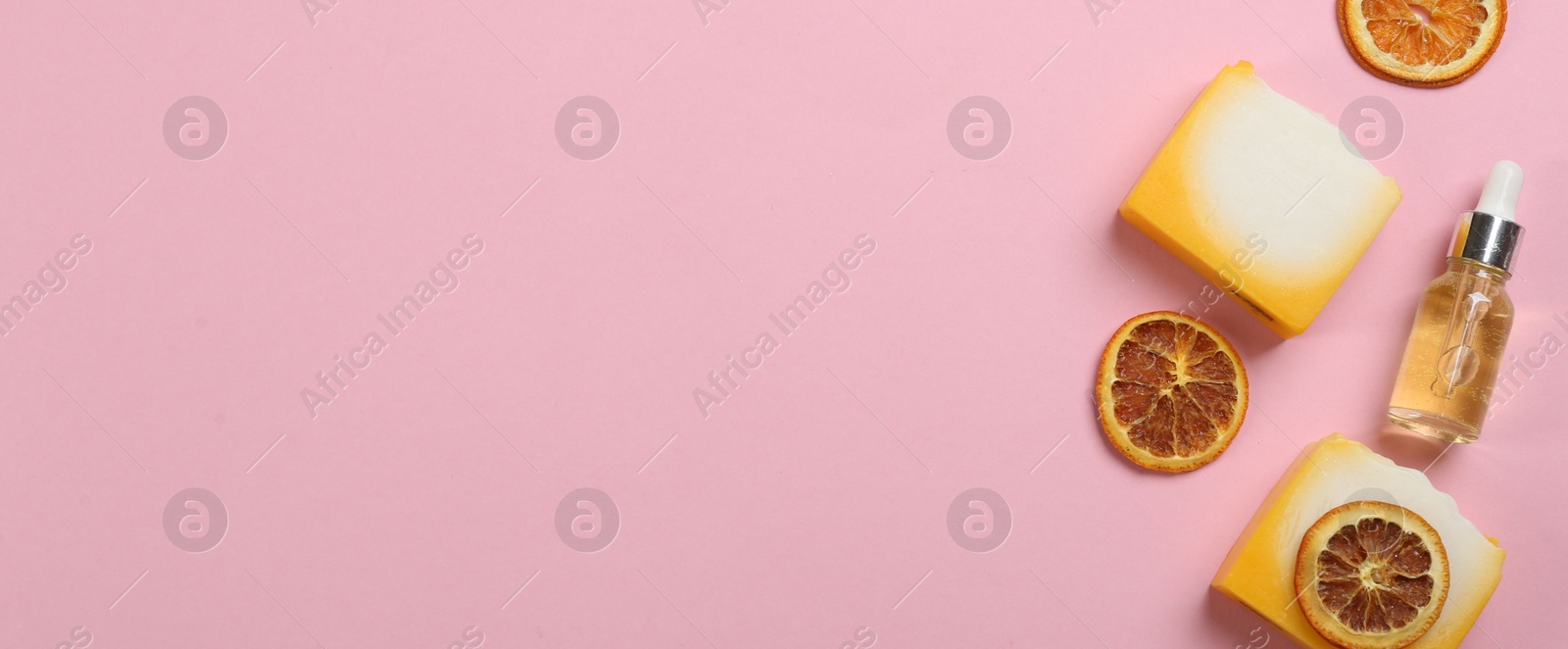 Photo of Flat lay composition with natural handmade soap and ingredients on pink background. Space for text