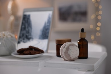 White wooden tray with spa products on bathtub in bathroom