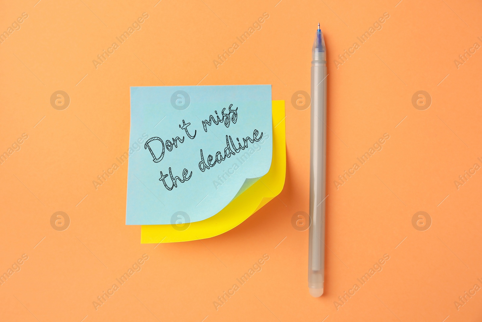 Image of Note with reminder Don't Miss The Deadline and pen on orange background, top view