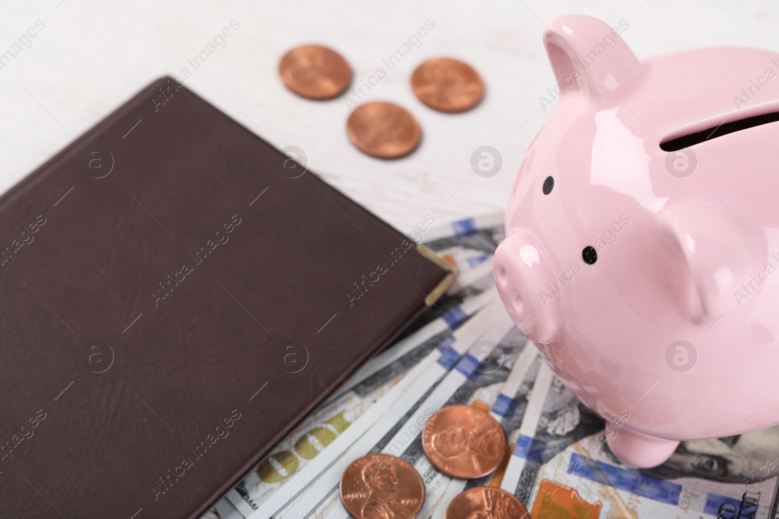 Photo of Pension certificate  with American money and piggybank on white wooden background