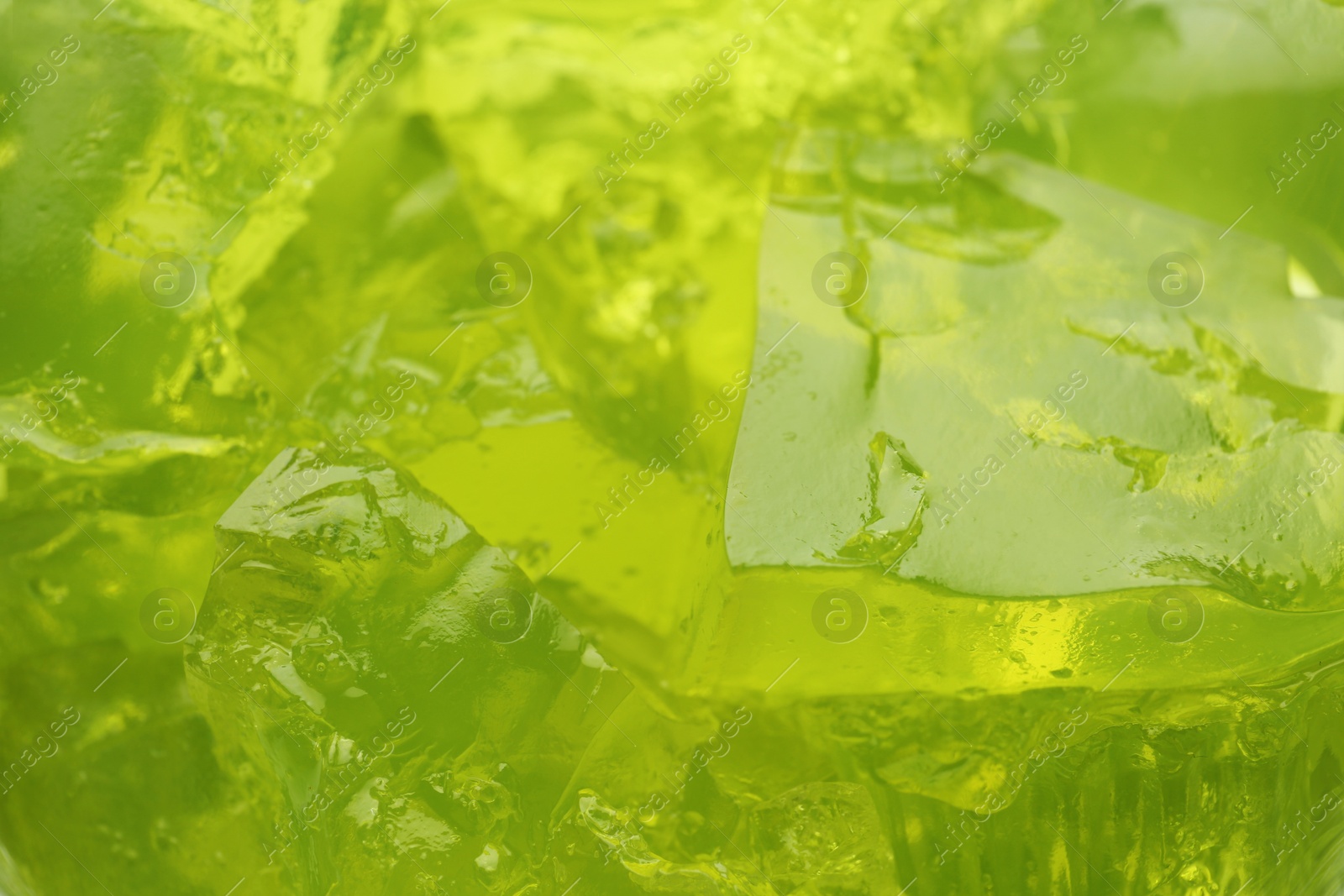 Photo of Green tasty fruit jelly as background, closeup