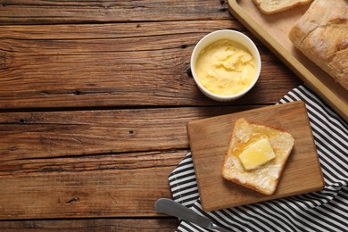 Photo of Melting butter, toast and knife on wooden table, top view. Space for text