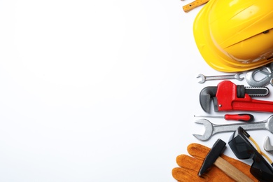 Composition with different construction tools on white background, top view