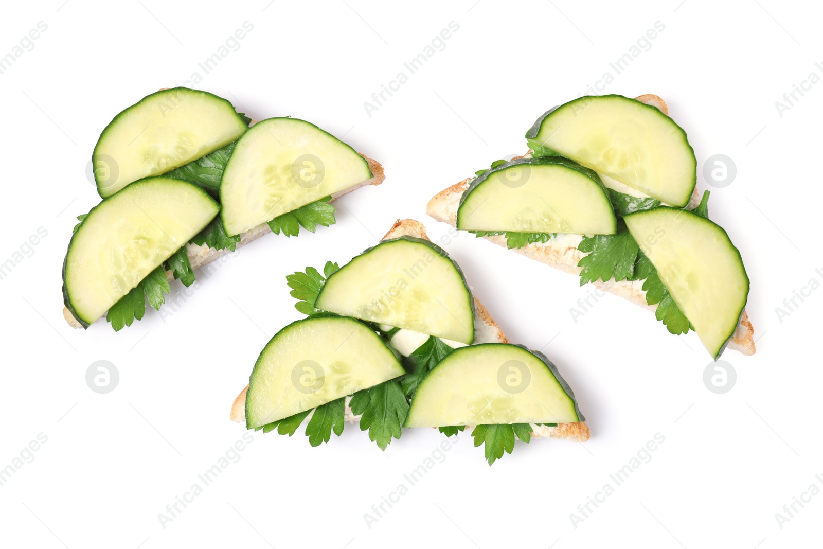 Photo of Tasty sandwiches with cucumber and parsley on white background, top view