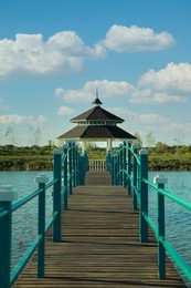 Photo of Beautiful view of bridge and gazebo on lake