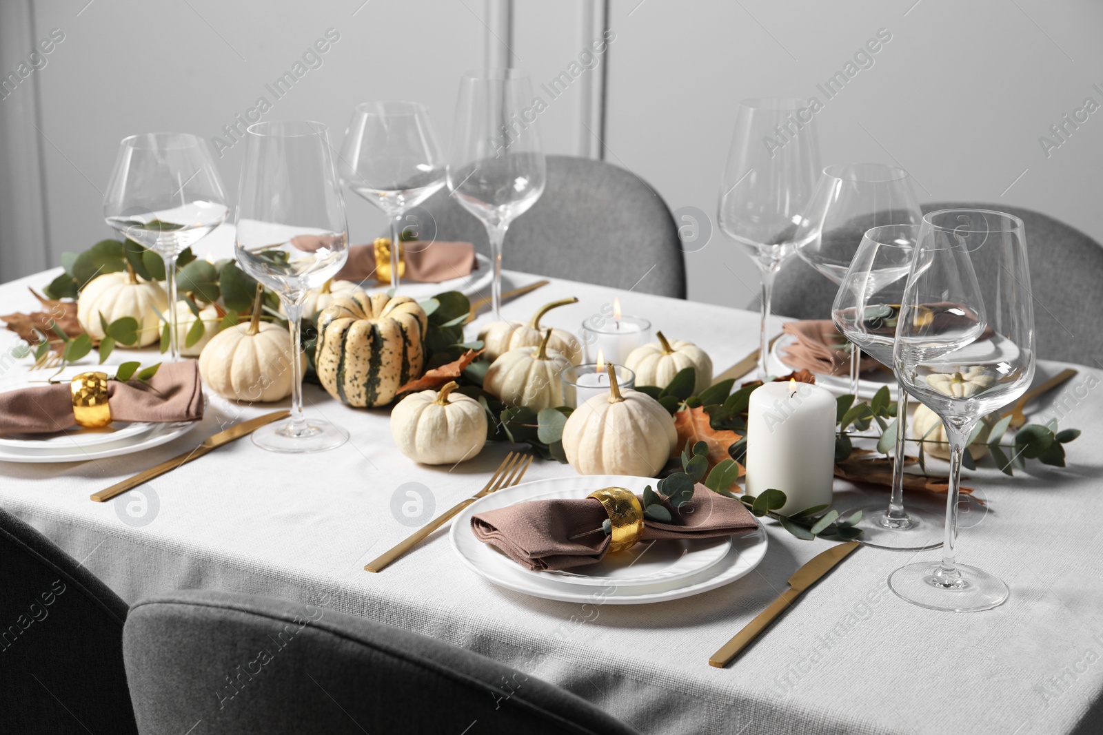 Photo of Beautiful autumn table setting. Plates, cutlery, glasses and floral decor indoors