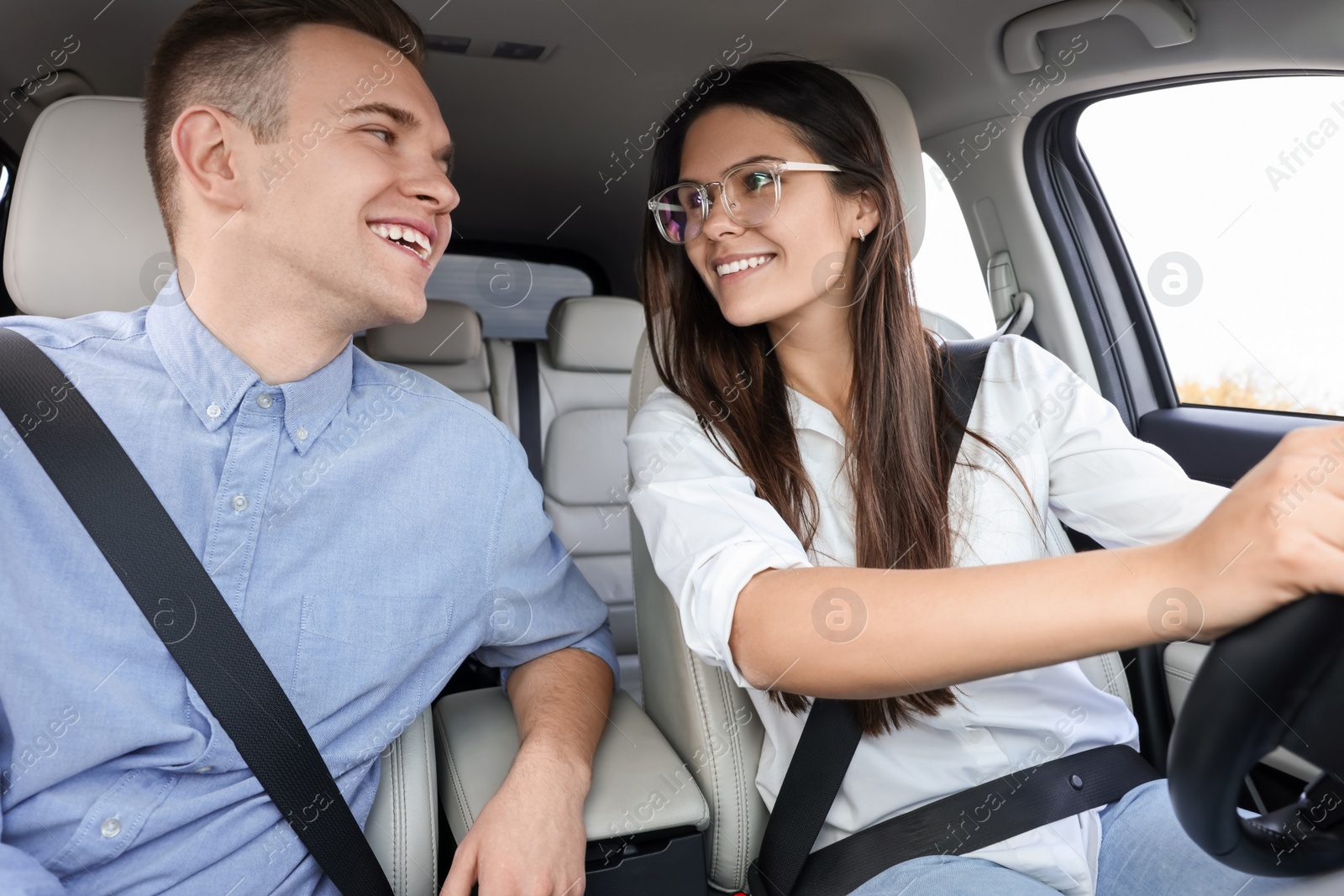 Photo of Happy young couple travelling together by car