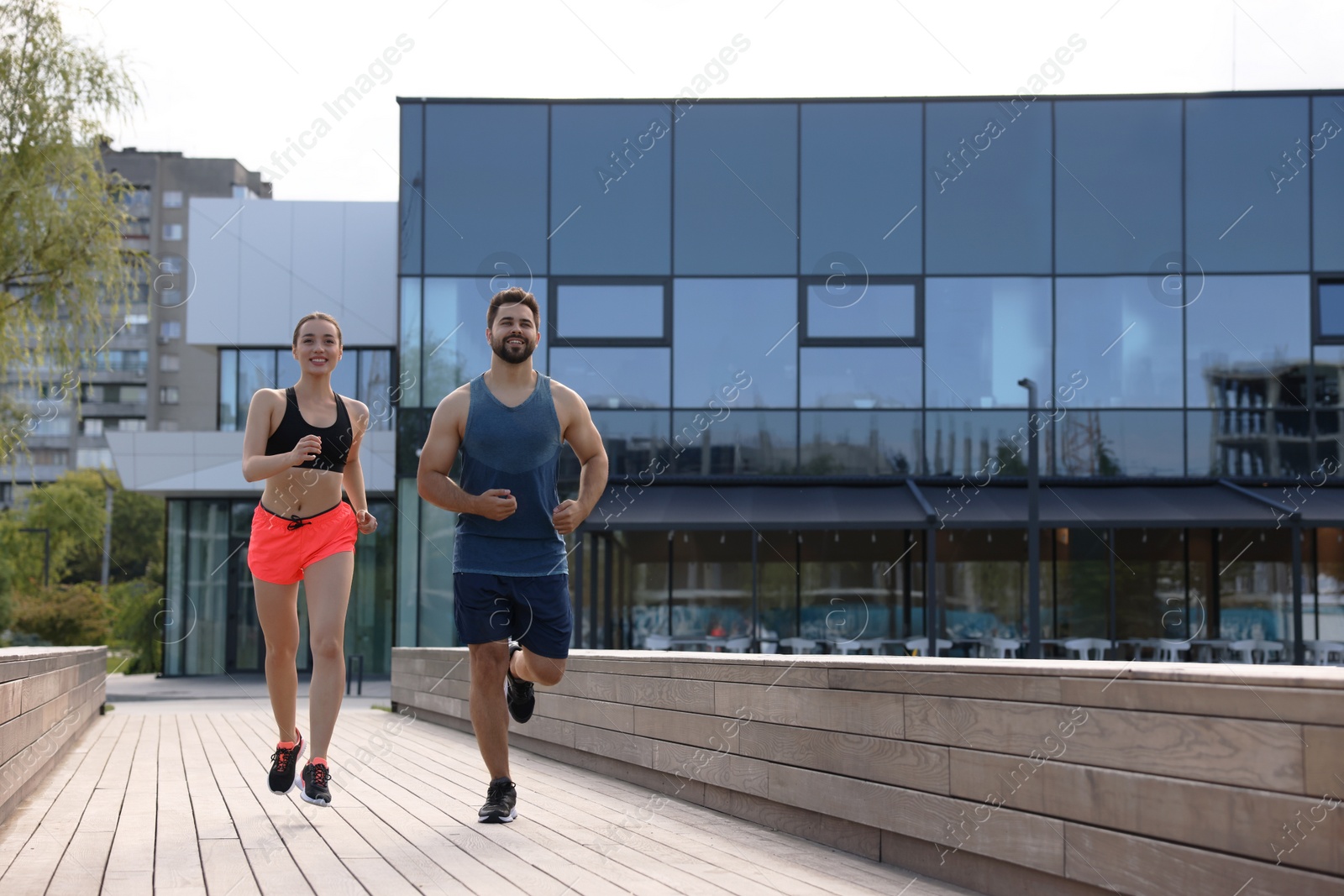 Photo of Healthy lifestyle. Happy couple running outdoors, space for text