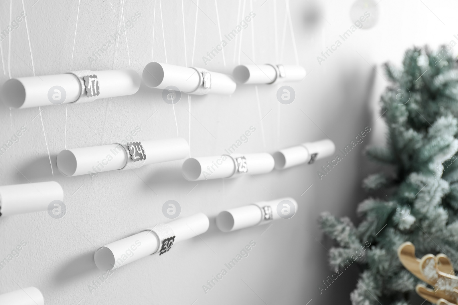 Photo of New Year advent calendar hanging on white wall indoors